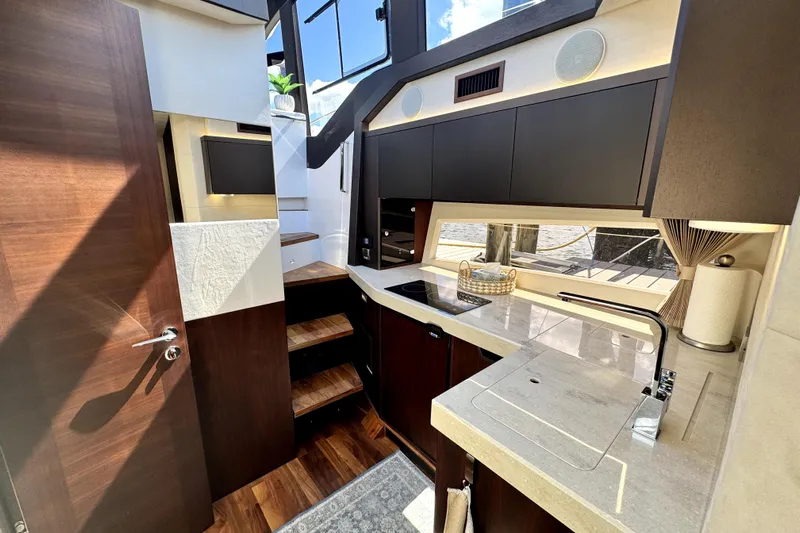  Yacht Photos Pics Modern kitchen interior of 2023 Galeon 425 HTS yacht with sleek cabinetry and natural light.