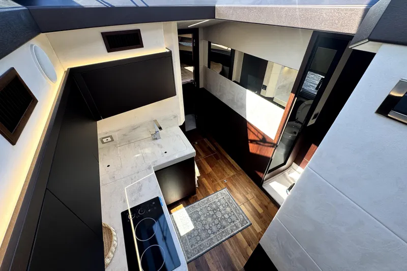  Yacht Photos Pics Modern interior of 2023 Galeon 425 HTS yacht with sleek kitchen and wooden flooring.