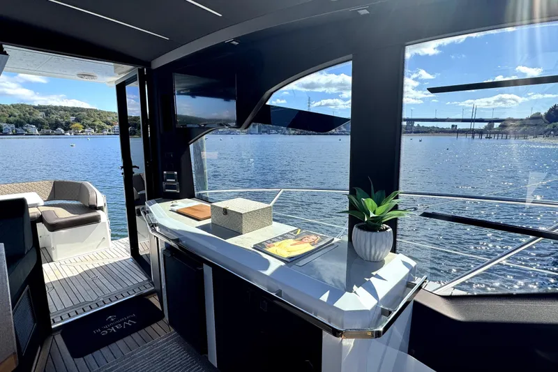  Yacht Photos Pics Interior view of 2023 Galeon 425 HTS yacht with scenic waterfront backdrop.