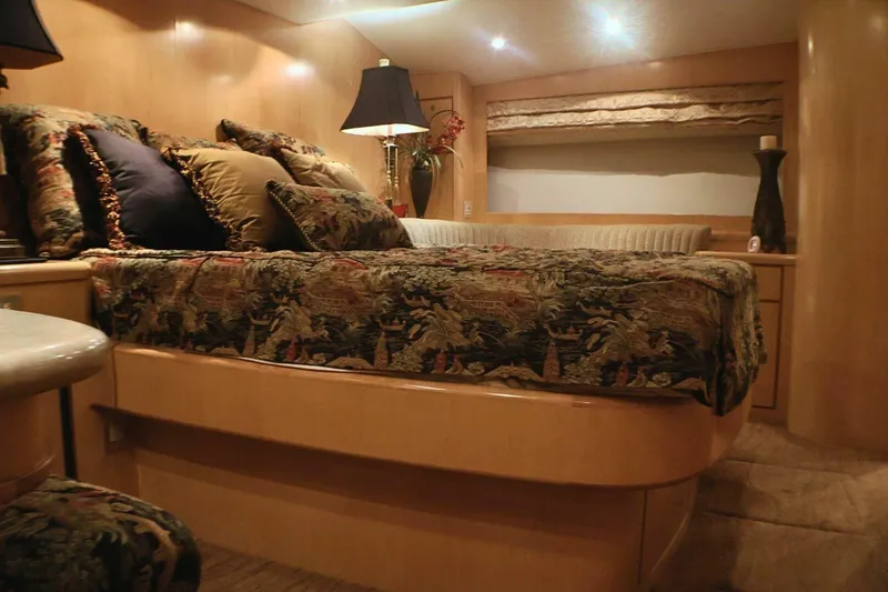  Yacht Photos Pics Luxurious bedroom interior of 2001 Donzi 73 Sport Yacht with elegant bedding and ambient lighting.