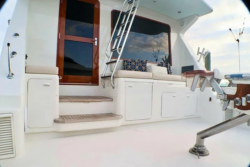  Yacht Photos Pics 2001 Donzi 73 Sport Yacht deck with seating, ladder, and wooden door.