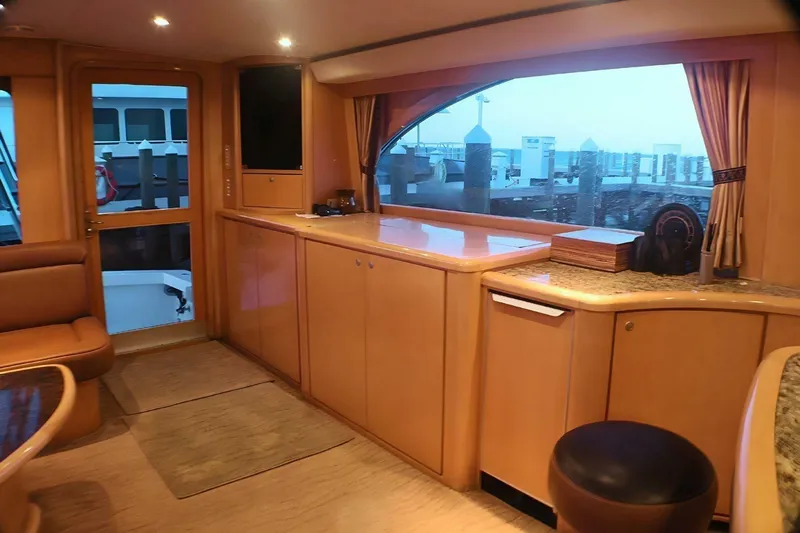  Yacht Photos Pics Interior of 2001 Donzi 73 Sport Yacht with elegant wood cabinetry and large window view.