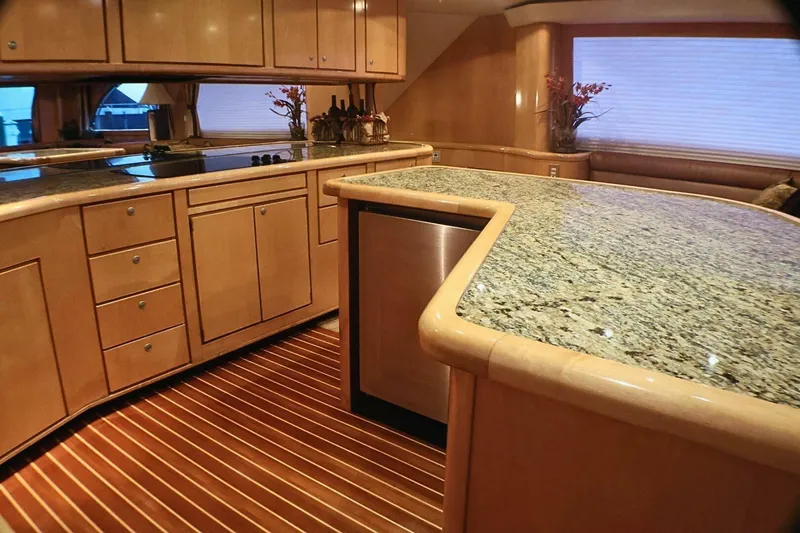  Yacht Photos Pics Luxurious kitchen interior of 2001 Donzi 73 Sport Yacht with granite countertops and wooden cabinetry.