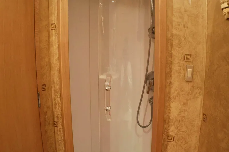  Yacht Photos Pics Shower area inside 2001 Donzi 73 Sport Yacht, featuring wooden accents and modern fixtures.