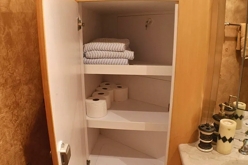  Yacht Photos Pics Cabinet with towels and toilet paper in 2001 Donzi 73 Sport Yacht bathroom.