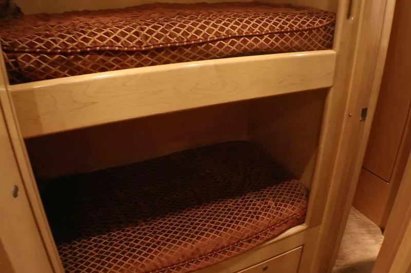  Yacht Photos Pics Interior of 2001 Donzi 73 Sport Yacht with wooden bunk beds and patterned cushions.