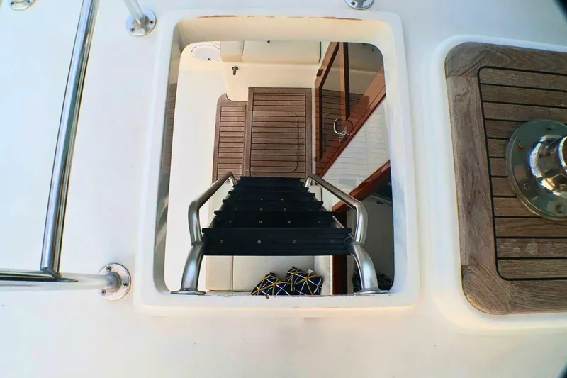  Yacht Photos Pics Staircase leading below deck on 2001 Donzi 73 Sport Yacht, featuring wooden and metal details.