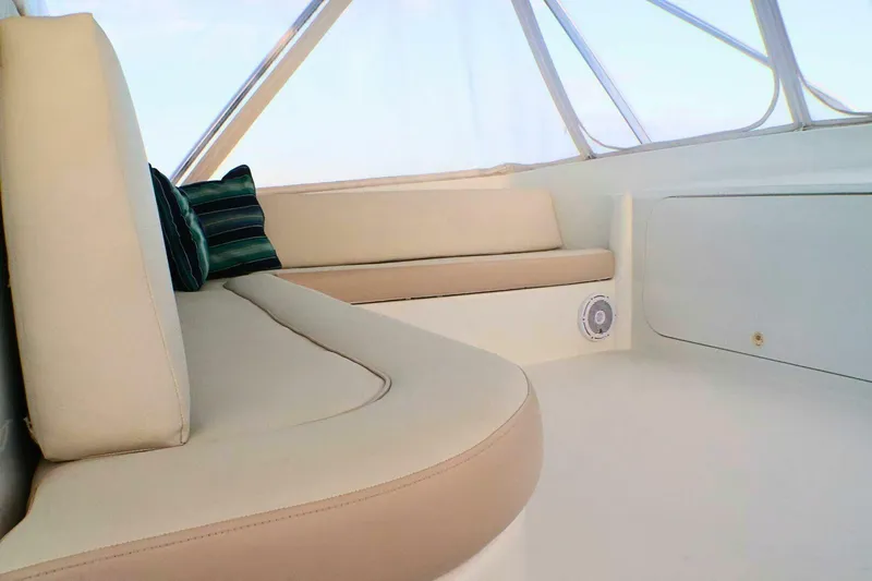  Yacht Photos Pics Interior seating of 2001 Donzi 73 Sport Yacht with beige cushions and striped pillows.