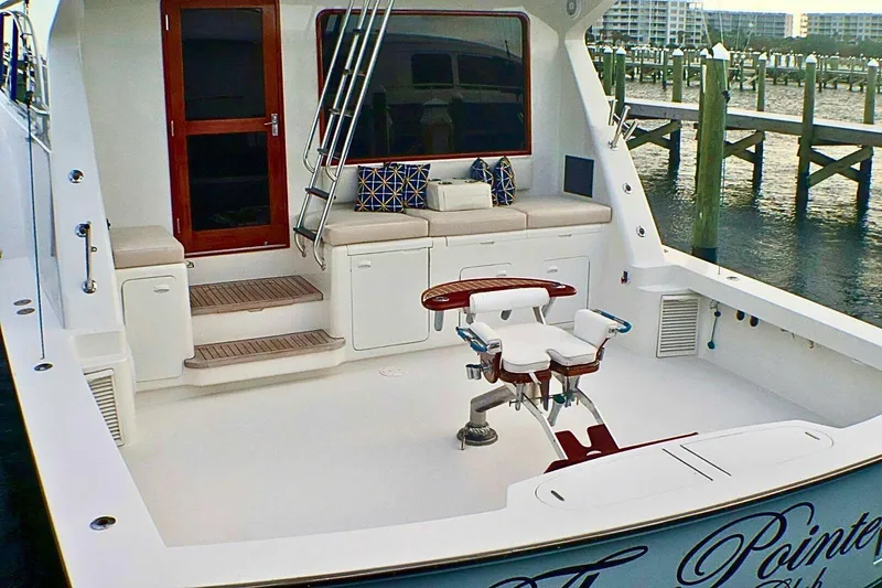  Yacht Photos Pics 2001 Donzi 73 Sport Yacht deck with seating and fishing chair, docked at marina.