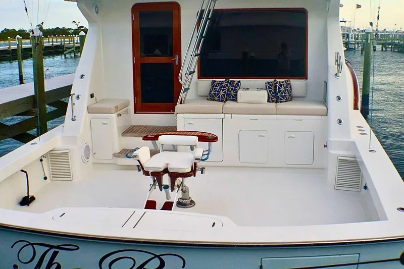  Yacht Photos Pics 2001 Donzi 73 Sport Yacht deck with seating and fishing chair, docked at marina.