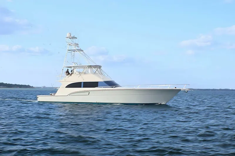  Yacht Photos Pics 2001 Donzi 73 Sport Yacht cruising on open water under a clear blue sky.