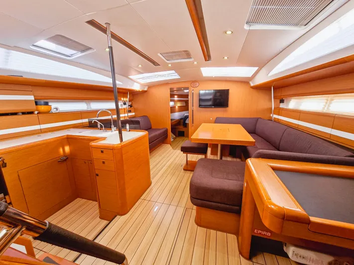  Yacht Photos Pics Luxurious interior of a 2015 Jeanneau 53 yacht with modern kitchen and seating area.