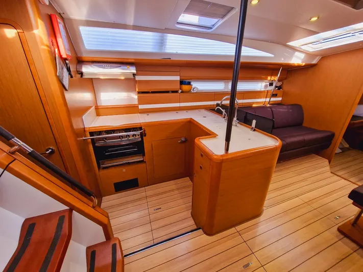  Yacht Photos Pics Interior of 2015 Jeanneau 53 yacht with modern kitchen and wooden flooring.