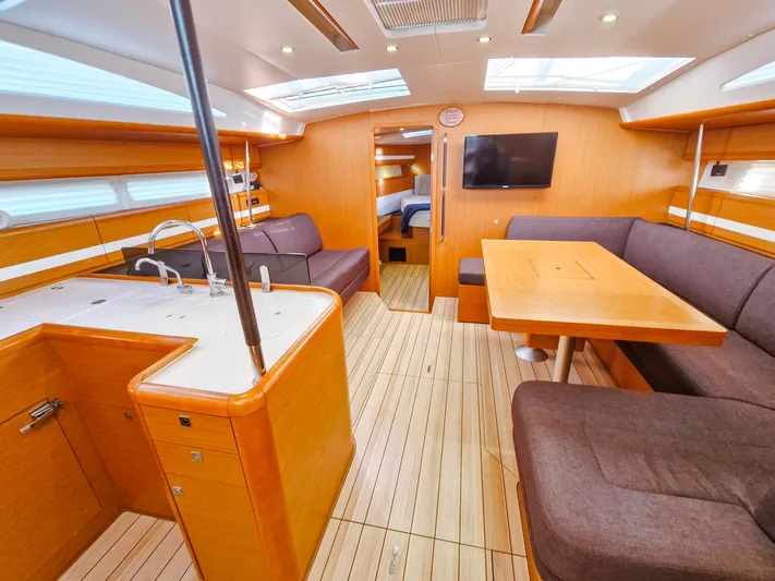  Yacht Photos Pics Interior of 2015 Jeanneau 53 yacht with modern kitchen and seating area.