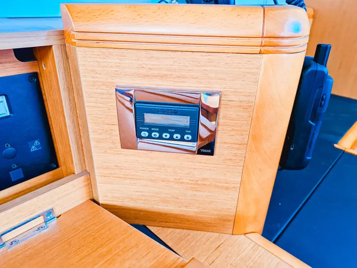  Yacht Photos Pics Control panel on a 2015 Jeanneau 53 yacht, featuring a sleek wooden finish.