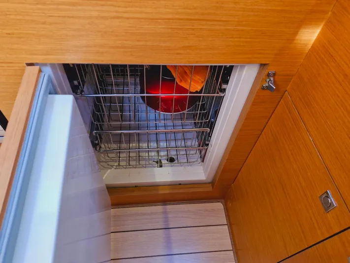  Yacht Photos Pics Built-in dishwasher on Jeanneau 53 yacht, 2015 model, with wooden cabinetry.