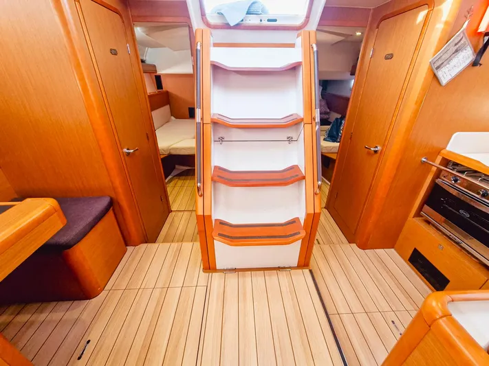  Yacht Photos Pics Interior of 2015 Jeanneau 53 yacht with wooden flooring and staircase.