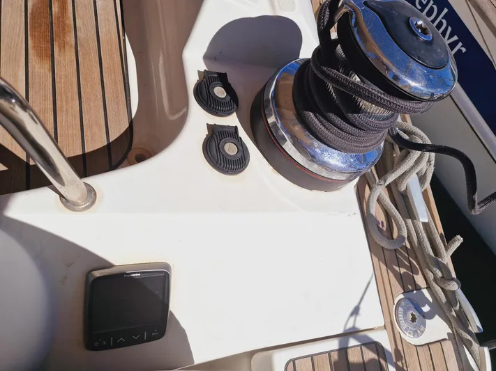  Yacht Photos Pics 2015 Jeanneau 53 yacht deck with winch, ropes, and wooden flooring.