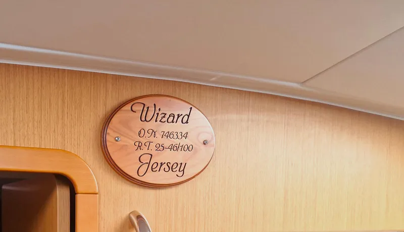  Yacht Photos Pics Plaque on Jeanneau 53 sailboat, 2015 model, with "Wizard Jersey" inscription.