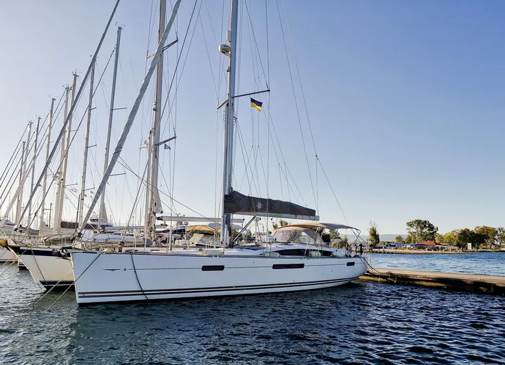  Yacht Photos Pics 2015 Jeanneau 53 yacht docked in a marina under clear blue skies.