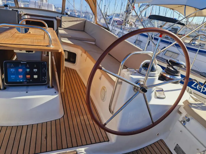  Yacht Photos Pics Cockpit of 2015 Jeanneau 53 sailboat with wooden deck and steering wheel.