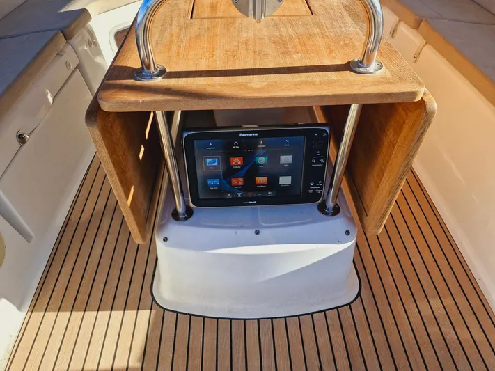  Yacht Photos Pics Navigation console on 2015 Jeanneau 53 yacht with Raymarine display and wooden paneling.