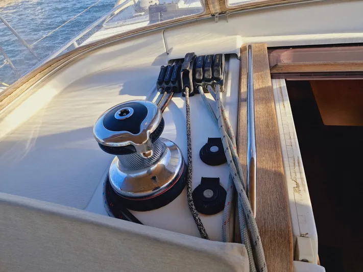  Yacht Photos Pics Winch and ropes on 2015 Jeanneau 53 sailboat deck, near cabin entrance.