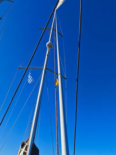  Yacht Photos Pics Mast of 2015 Jeanneau 53 sailboat against clear blue sky.