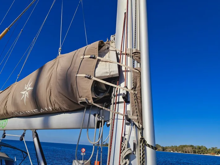  Yacht Photos Pics Jeanneau 53 sailboat mast and sail cover against clear blue sky, 2015 model.