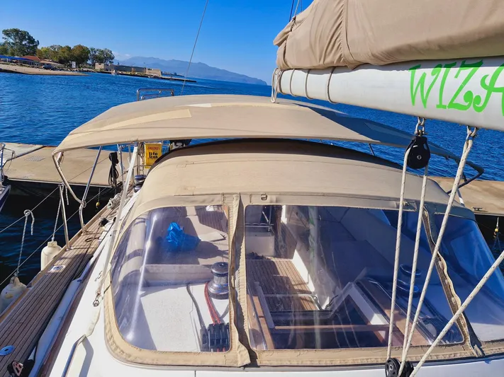  Yacht Photos Pics Jeanneau 53 sailboat, 2015 model, docked with beige canopy, clear skies, and calm waters.