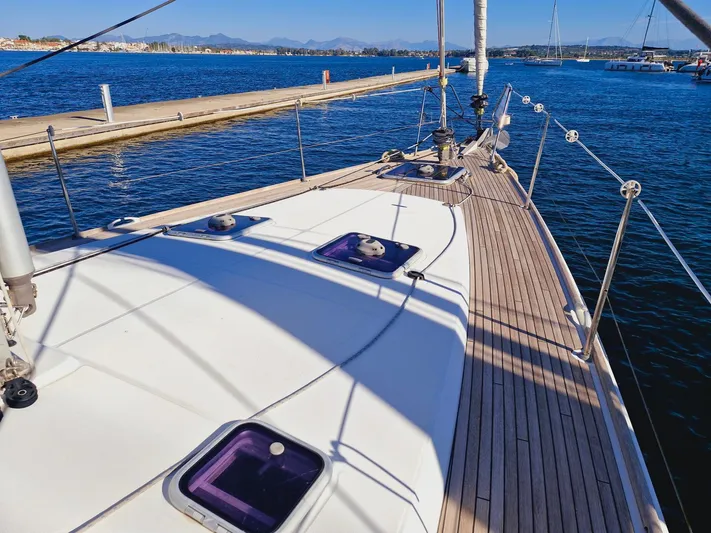  Yacht Photos Pics Deck view of a 2015 Jeanneau 53 sailboat docked at a marina.