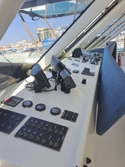 Salone Yacht Photos Pics Control panel of a 2015 Power Catamaran with navigation equipment and cityscape in the background.