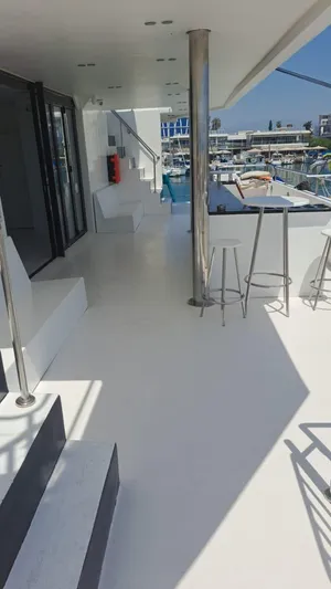 Salone Yacht Photos Pics Modern 2015 Power Catamaran deck with seating, bar stools, and marina view.