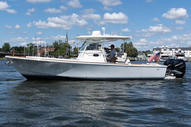 Hunt 32cc-035 Yacht Photos Pics 2019 Hunt Yachts 32CC boat cruising on a sunny day with American flag.