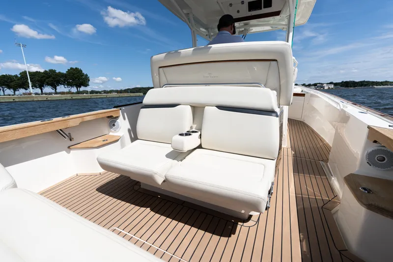 Hunt 32cc-035 Yacht Photos Pics 2019 Hunt Yachts 32CC boat interior with luxurious seating and teak flooring on a sunny day.