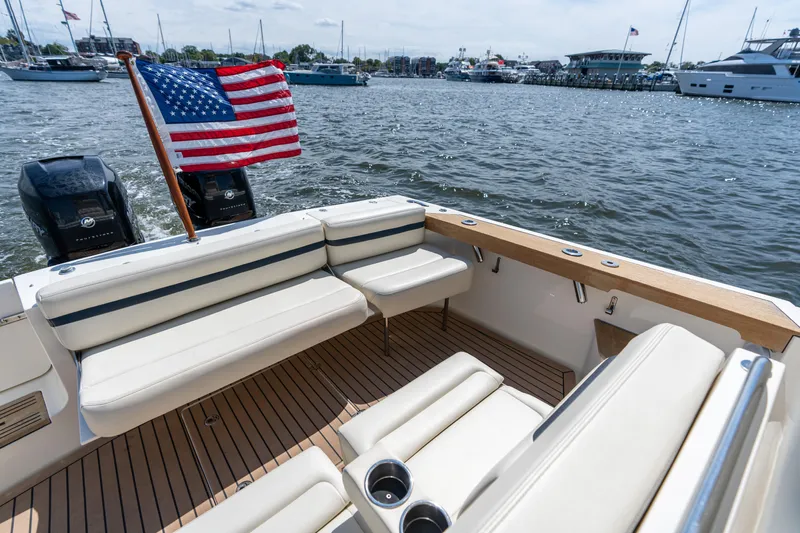Hunt 32cc-035 Yacht Photos Pics 2019 Hunt Yachts 32CC boat interior with American flag, docked in a marina.