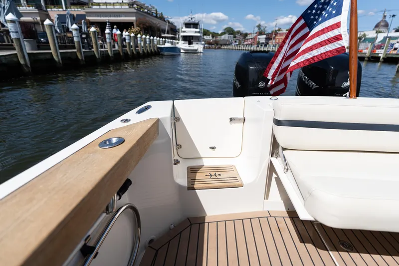 Hunt 32cc-035 Yacht Photos Pics 2019 Hunt Yachts 32CC boat with American flag, docked in a marina.