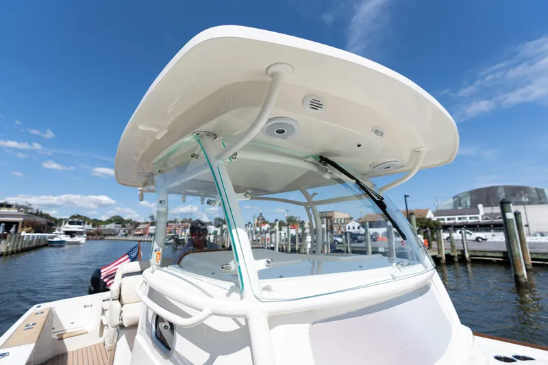 Hunt 32cc-035 Yacht Photos Pics 2019 Hunt Yachts 32CC boat docked at marina under clear blue sky.
