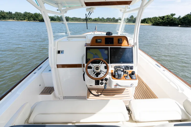 Hunt 32cc-035 Yacht Photos Pics 2019 Hunt Yachts 32CC boat cockpit with modern navigation system and wooden accents.
