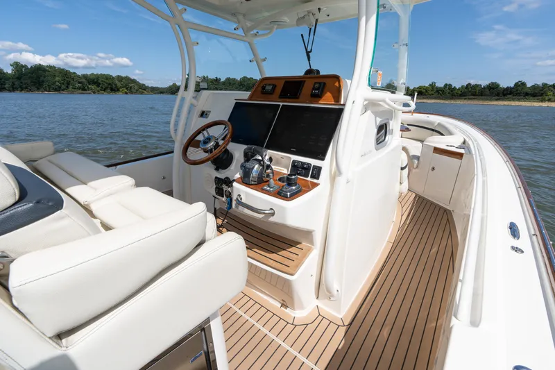 Hunt 32cc-035 Yacht Photos Pics 2019 Hunt Yachts 32CC boat interior with helm, steering wheel, and navigation equipment.