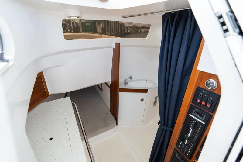 Hunt 32cc-035 Yacht Photos Pics Interior of 2019 Hunt Yachts 32CC, featuring a compact cabin with sink and control panel.