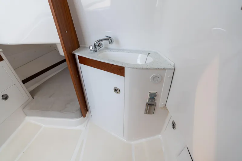 Hunt 32cc-035 Yacht Photos Pics 2019 Hunt Yachts 32CC interior with compact sink and wooden accents.