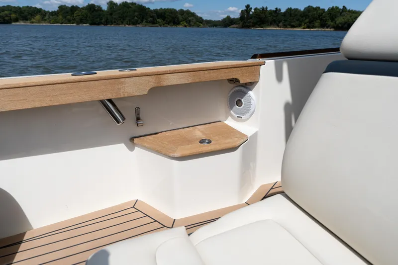 Hunt 32cc-035 Yacht Photos Pics 2019 Hunt Yachts 32CC interior detail with wood accents and speaker, overlooking serene water.