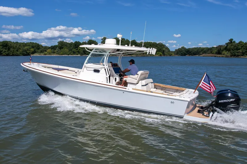 Hunt 32cc-035 Yacht Photos Pics 2019 Hunt Yachts 32CC cruising on a scenic lake with American flag.