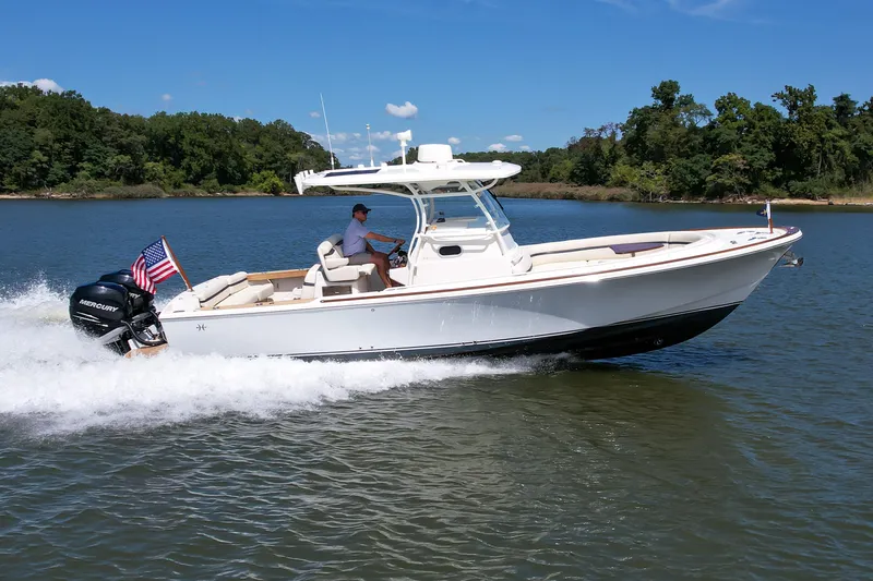 Hunt 32cc-035 Yacht Photos Pics 2019 Hunt Yachts 32CC cruising on a lake with lush green shoreline.
