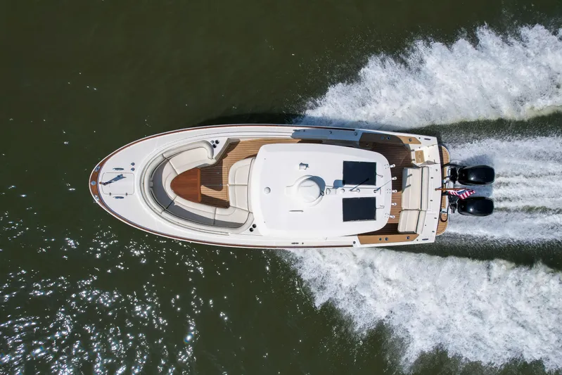 Hunt 32cc-035 Yacht Photos Pics Aerial view of 2019 Hunt Yachts 32CC cruising on water, showcasing sleek design and powerful engines.