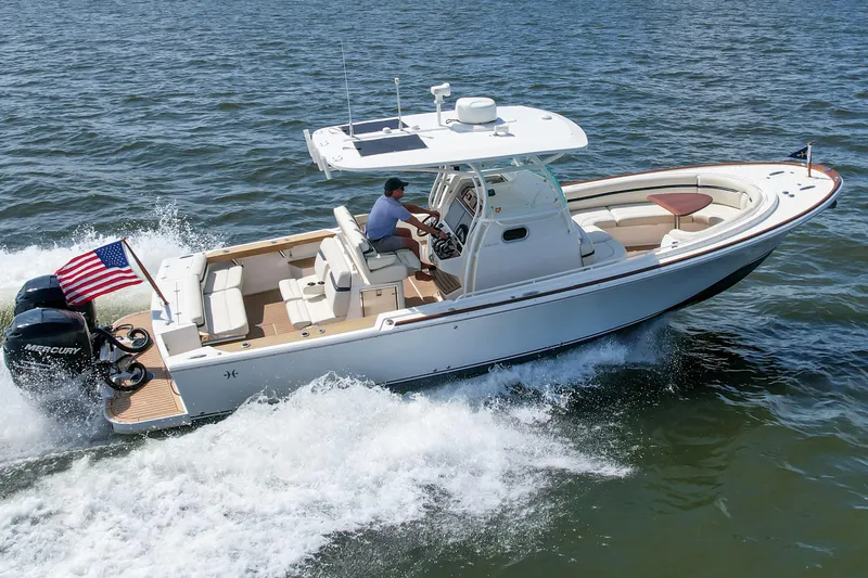 Hunt 32cc-035 Yacht Photos Pics 2019 Hunt Yachts 32CC cruising on open water with American flag.