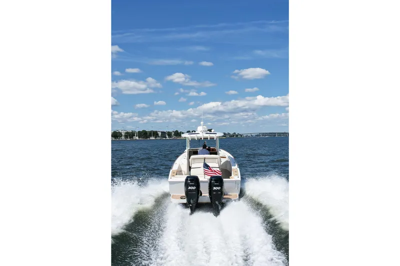 Hunt 32cc-035 Yacht Photos Pics 2019 Hunt Yachts 32CC cruising on open water under a clear blue sky.