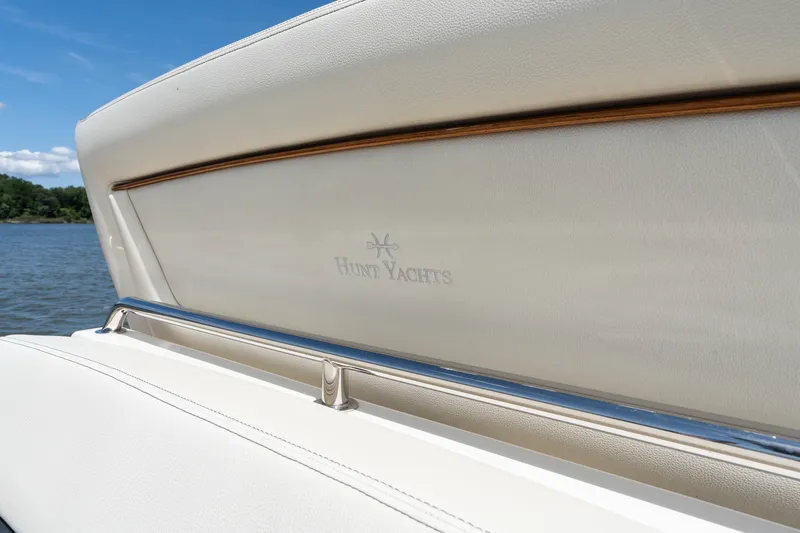 Hunt 32cc-035 Yacht Photos Pics 2019 Hunt Yachts 32CC boat interior with logo, featuring elegant white upholstery.