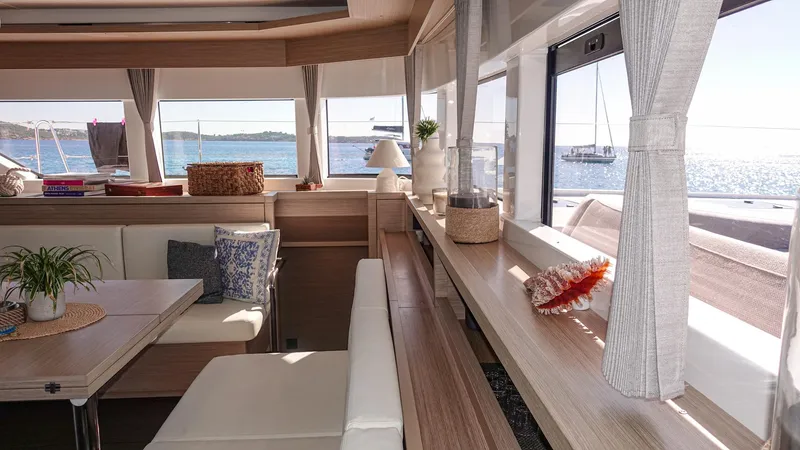 Esperance Yacht Photos Pics Luxurious interior of 2024 Lagoon 55 yacht with ocean view and elegant decor.